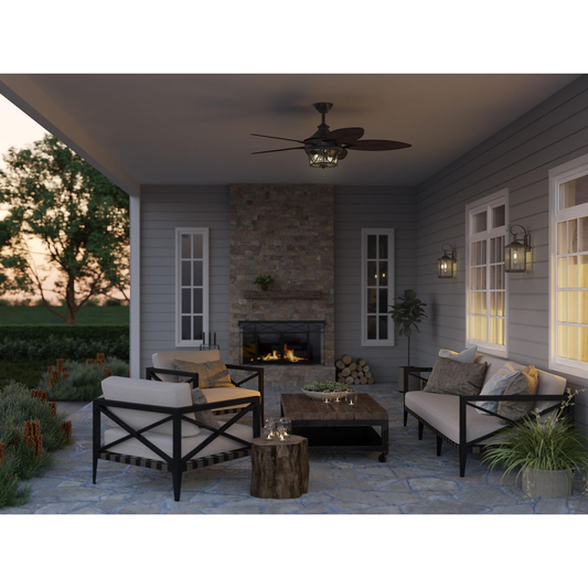 Architectural bronze-finished ceiling fan with a clear seeded glass shade.